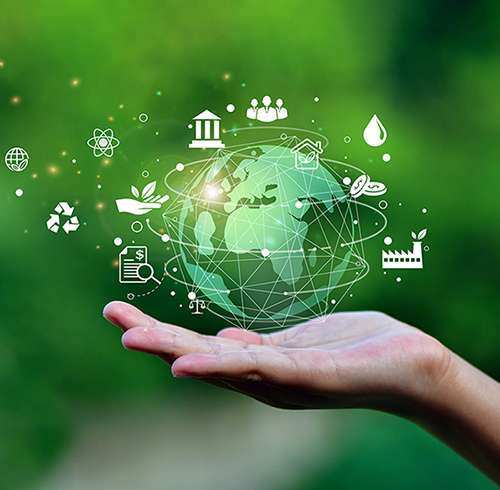 A hand holding an illustration of the world surrounded by sustainability symbols